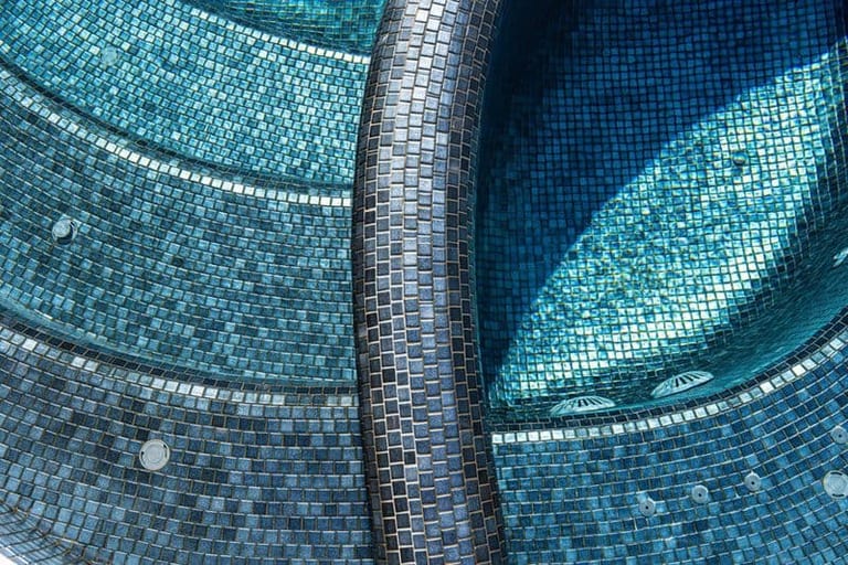Overhead view of the spa and its curved tiled wall, jets ringing the floor.
