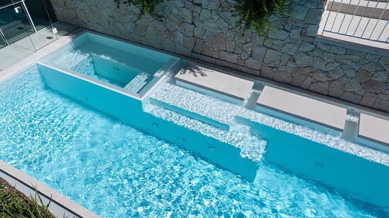 The spa and its spillway seen from above, water sheeting down into the main pool.