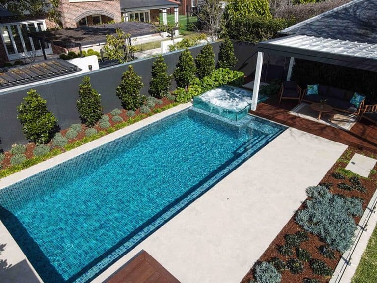 Elevated view of the long pool, glass spa and the terrace running beside it.